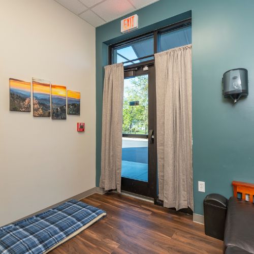 A cozy room featuring a bed and a door leading to the outside
